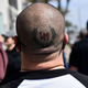 A tattoo detail on the head of a man as as he is confronted by anti-racism protesters following a planned “White Lives Matter’” demonstration on April 11, 2021 in Huntington Beach, California.